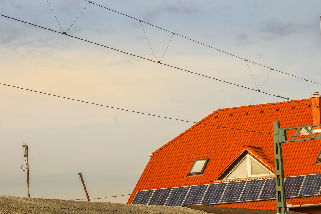 service-04 orange-roof-with-solar-panels-and-overhead-wires-iowviwkyjra